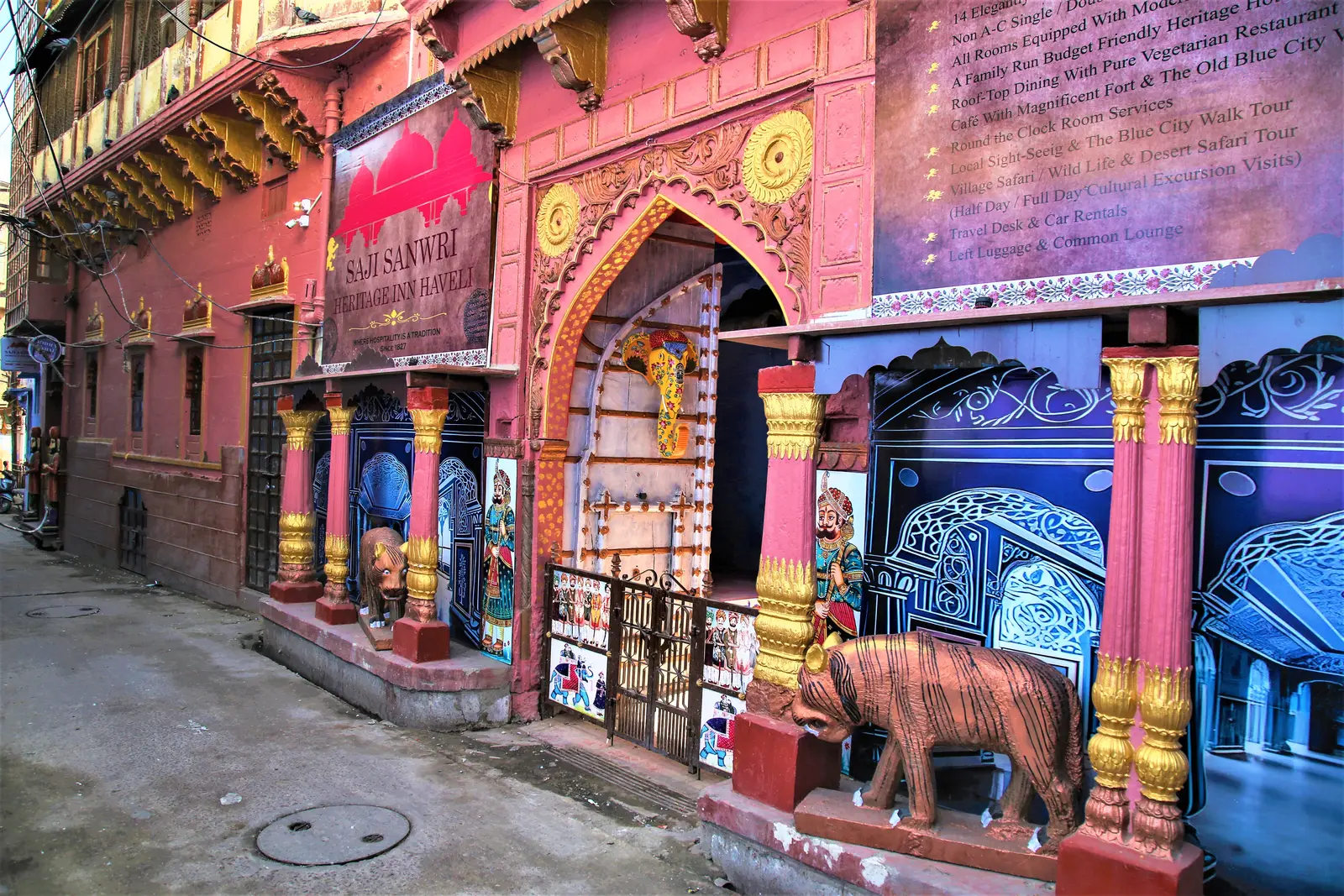 Pink and indigo painted haveli street facade with hand painted murals in Jodhpur old city