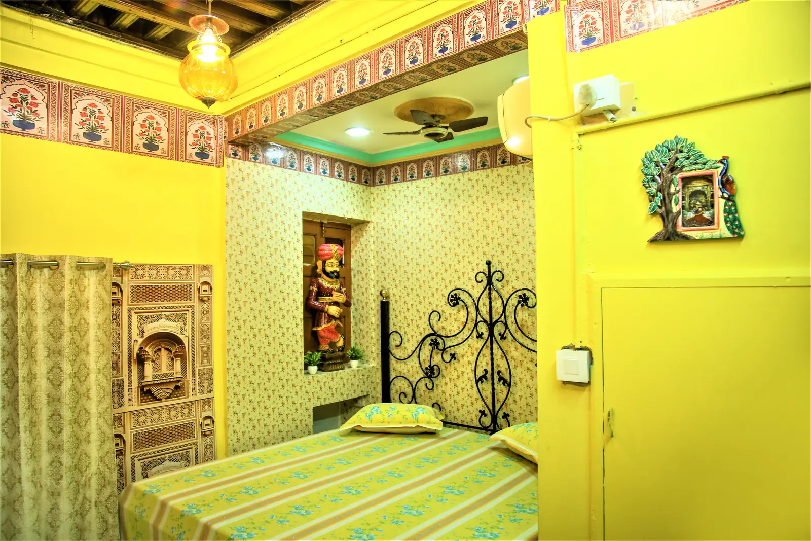 Imperial Deluxe Room with king size bed, carved niches and fort view window at the Jodhpur haveli