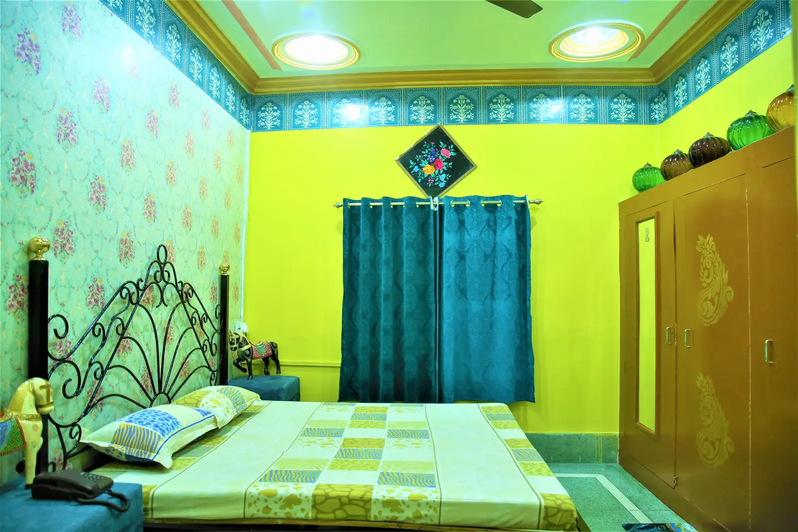 Sovereign Deluxe Room with wrought iron bed, wardrobe and fort view gallery window in Jodhpur